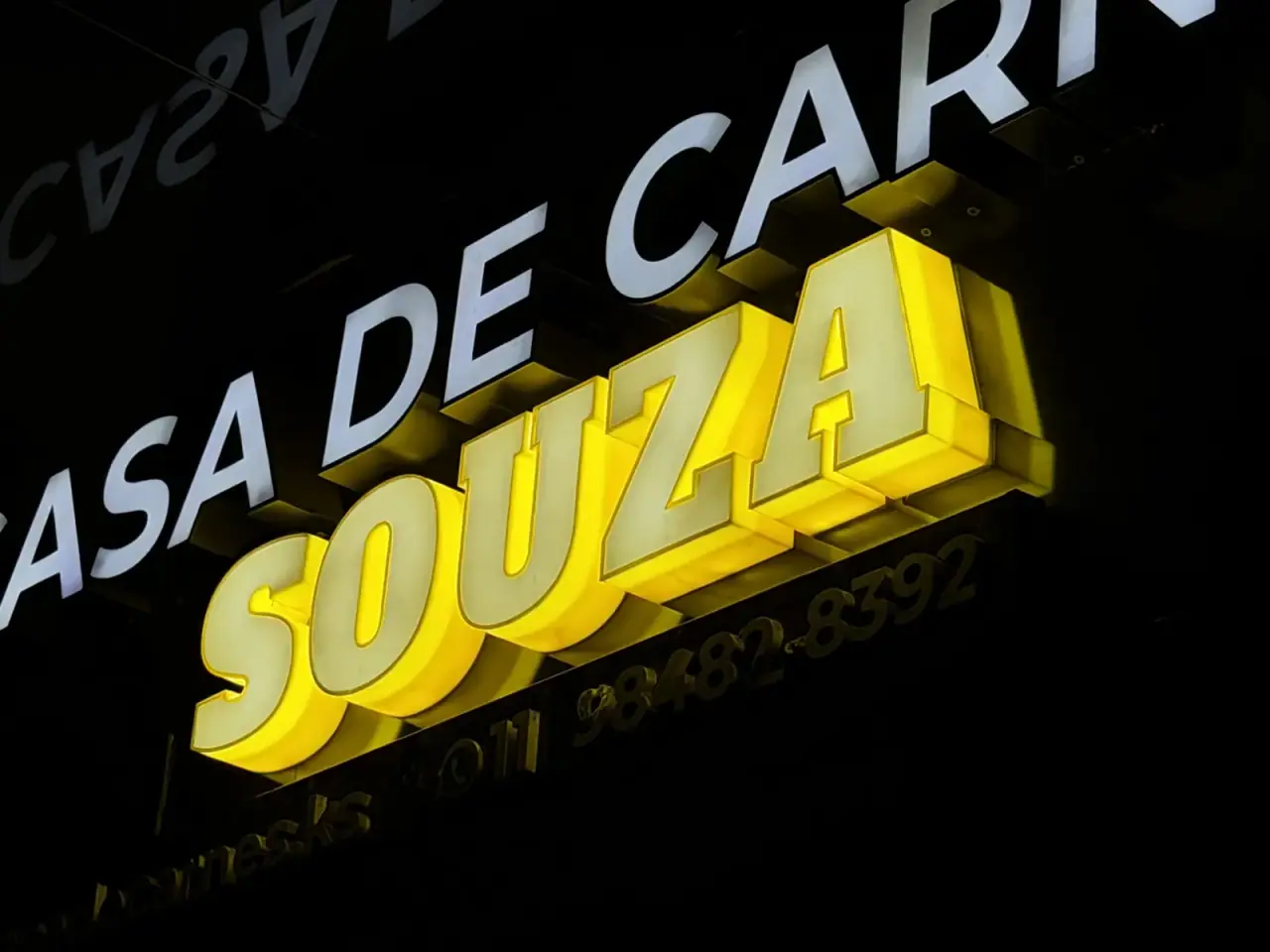 Letreiro luminoso da Casa de Carnes Souza com letra caixa amarela — foto 3