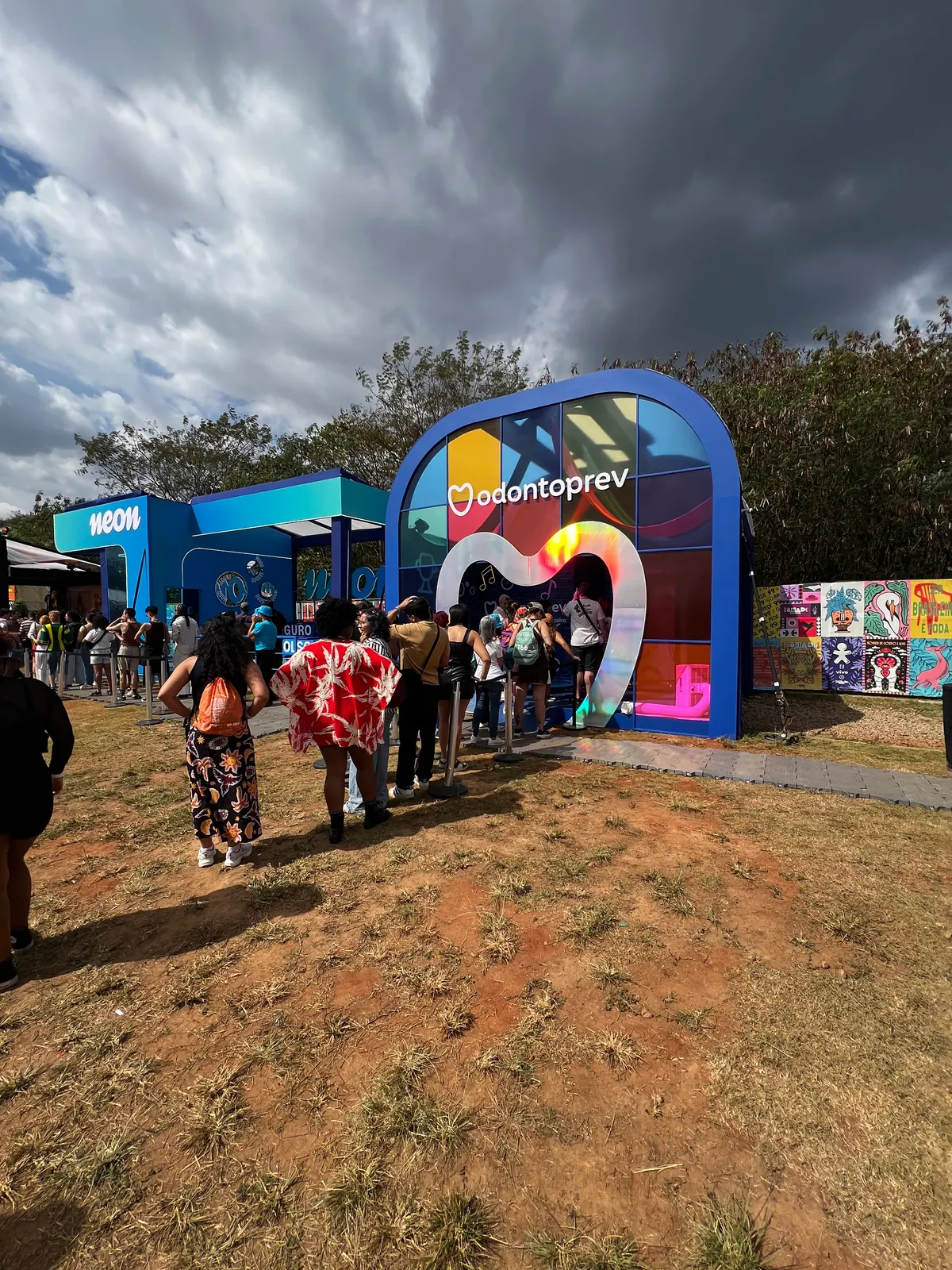 Espaço da Odontoprev em festival com entrada em coração iluminado e cenário de neon — foto 1